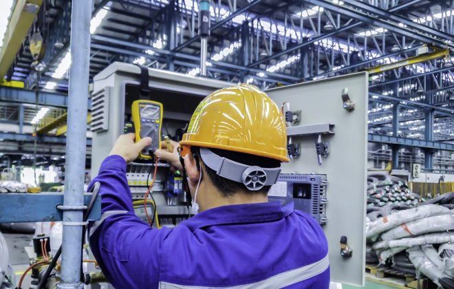 Blur background of electrical engineer are working on factory site, Technician check fault in power control unit on factory site, Electrician are checking fault in control box