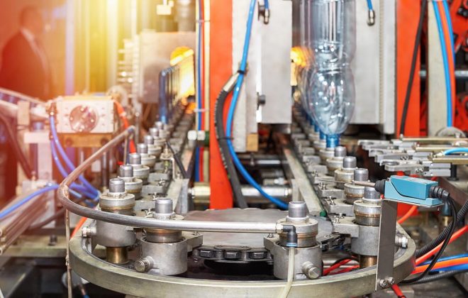 A closeup of a modern automated line for the production of plastic bottles for water and beverages.